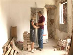 A man and a mature woman engaged in debauchery at a construction site