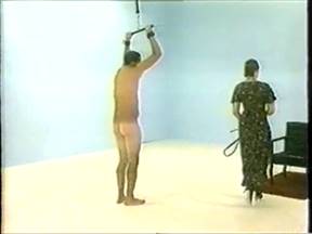 A woman jerks off and beats a man with a whip